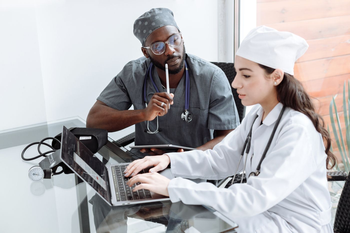 Two clinicians reviewing information together at a workstation